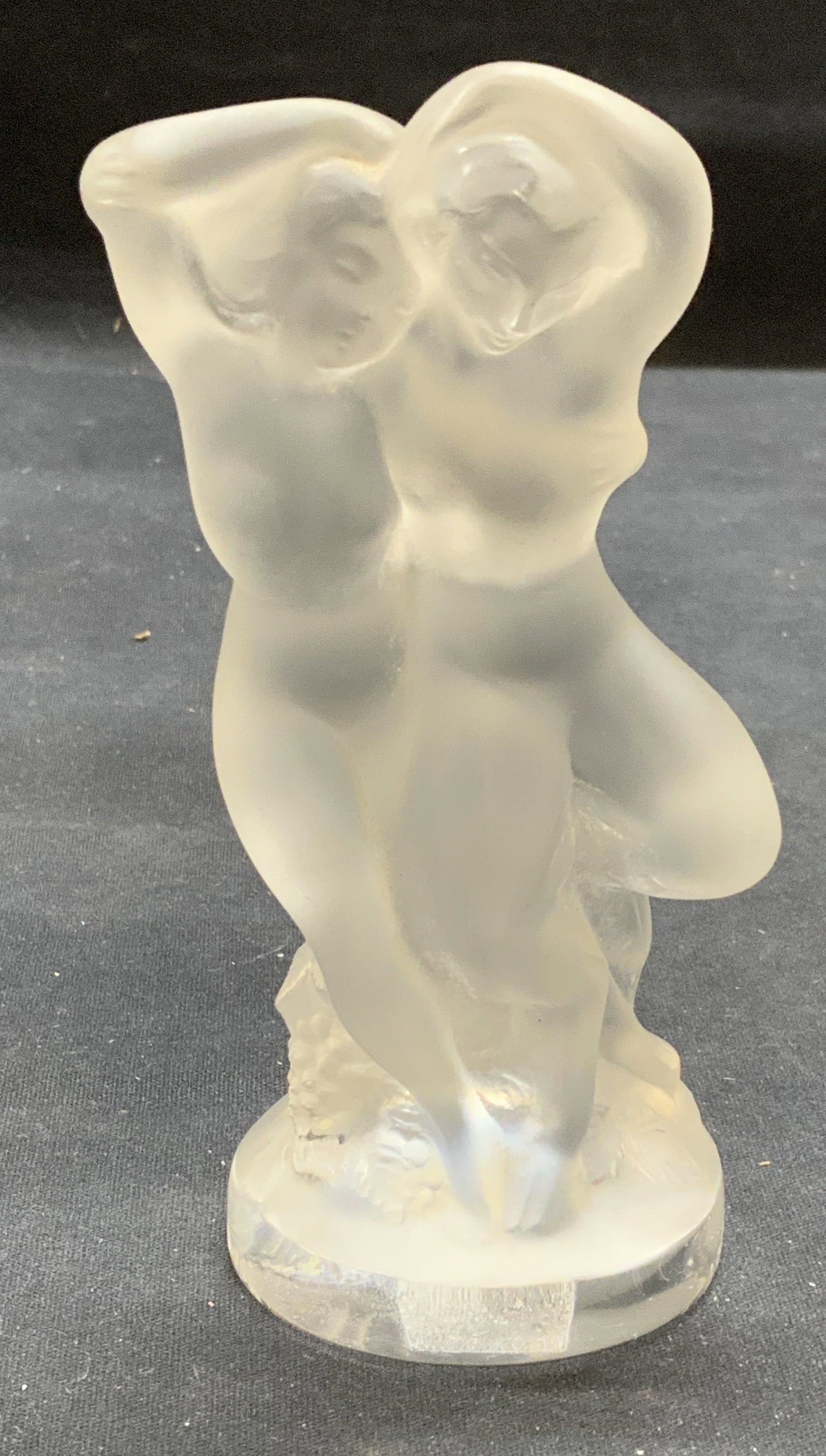 Lalique Crystal Woman & Faun Figurine, France: Lalique crystal figurine. Woman with Faun. Signed to base, sticker to underside. Some surface wear including scratches observed. Made in France. Measures approx. 2.5 x 2 x 5.5 inches. Lalique, Lalique