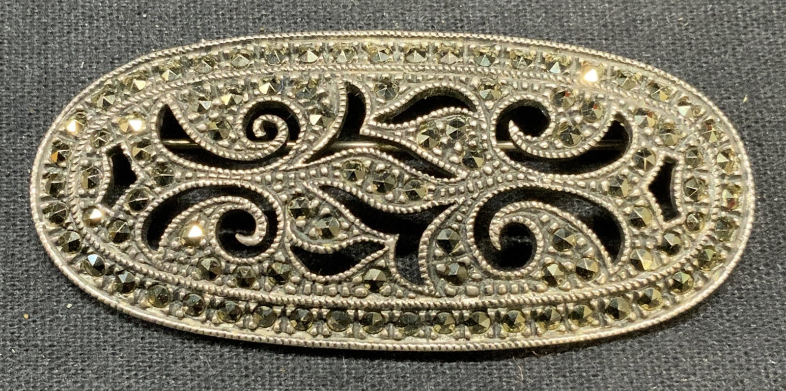 Sgn JJ Sterling Silver Marcasite Art Deco Brooch: Signed sterling silver and marcasite decorated art deco brooch. Signed J J in Diamond to underside. Marked sterling. Measures approx. 2.25 x 1 inches. Some surface wear including scratching observed. 
