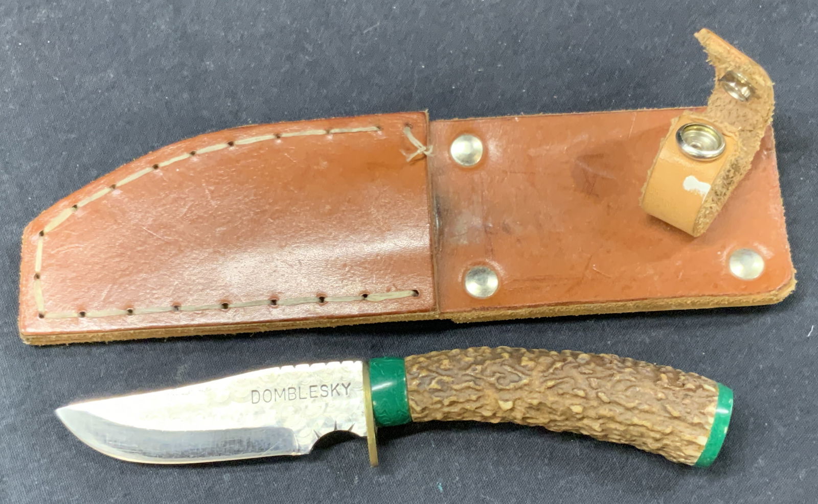 Sam Domblesky Malachite & Horn Handle Knife: Marked on blade Domblesky. Steel knife with malachite capping to handle and handle made of animal antler. Comes with leather belt carrying case. knife is approx 7.5 inches long, with a blade of 3.5 in