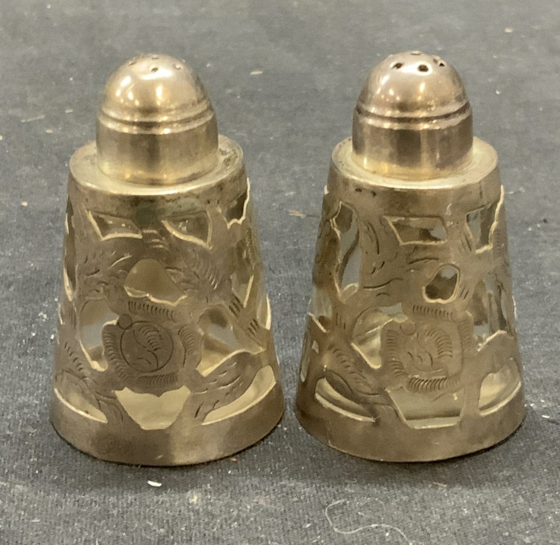 Antique LHM Mexico Sterling Silver Shakers: Antique pair of LHM Mexico sterling silver and glass salt and pepper shakers. Trademarked to undersides. Marked 925, sterling, made in Mexico. Some surface wear including scratching observed. Measure 