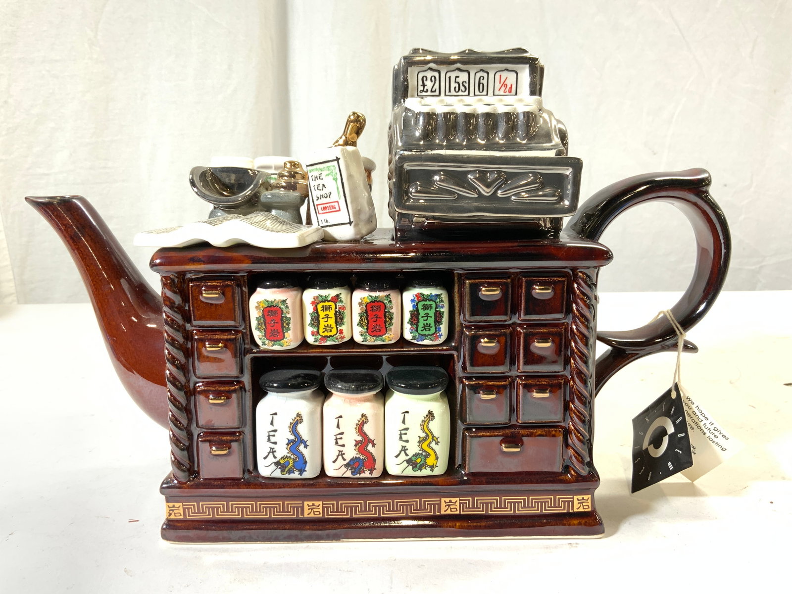 PAUL CARDEW Teashop Counter Porc Tea Pot W Lid NWT: Underside is signed P CARDEW & Trademarked CARDEW DESIGN MADE IN ENGLAND. Teapot has trademarked tag attached. Teapot appears to be porcelain possibly ceramic. Includes lid shaped as cash register. Pi