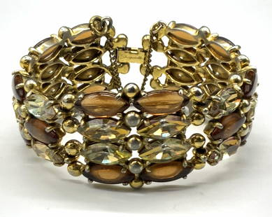 ELSA SCHIAPARELLI Signed Vintage Crystal Bracelet: Circa 1950s faceted pale citrine and polished amber hued navette crystal bracelet. Gold tone metal spheres between the crystals. Clasp closure signed SCHIAPARELLI. Safety chain closes with c-spring cl