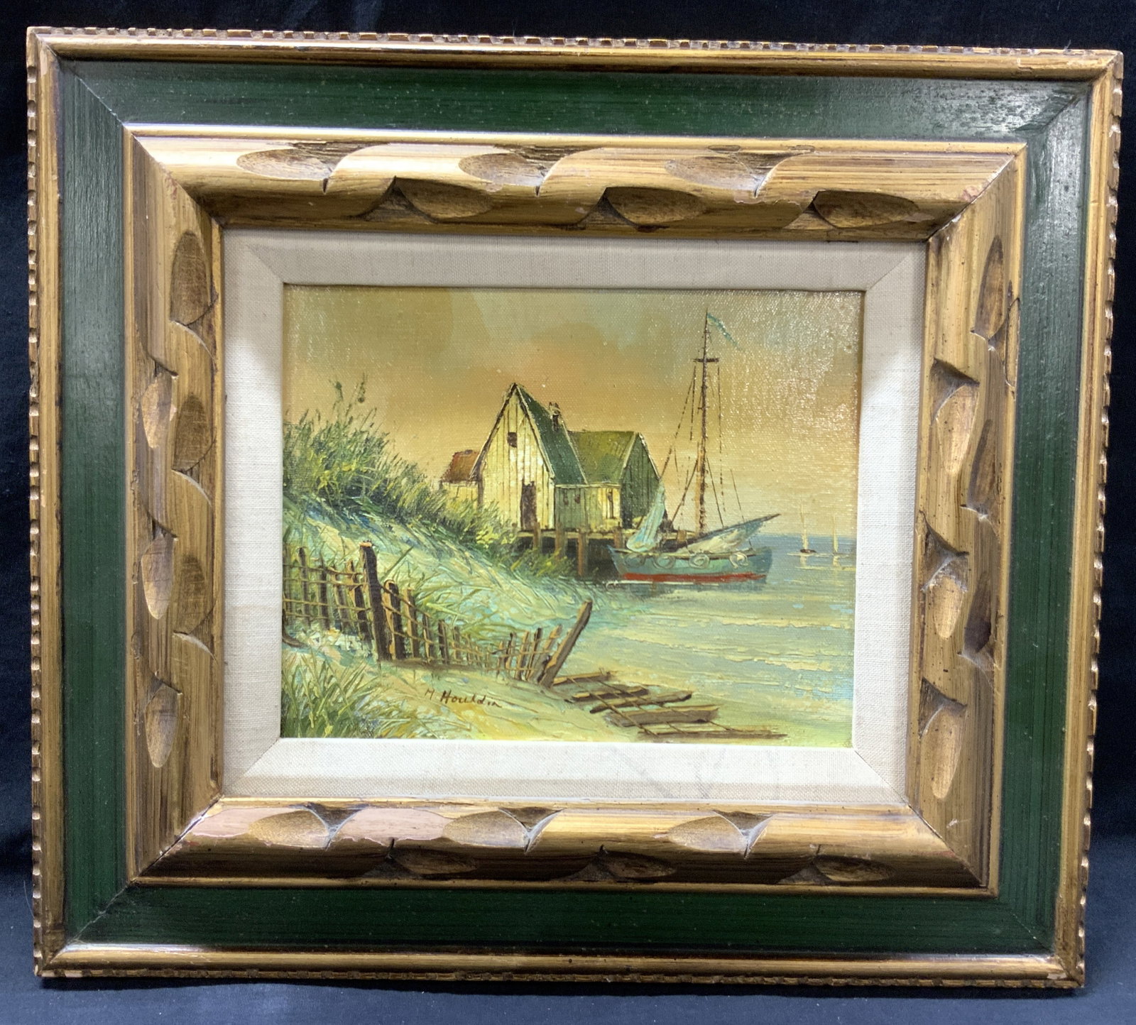 M.Houldin Signed Sail Boat On Dock Oil Painting: Signed in lower left corner M.Houldin Subject depicts a sail boat on a dock to a building on shoreline Framed in carved gold painted wooden and green frame Approximately 15 x 17 inches window measures