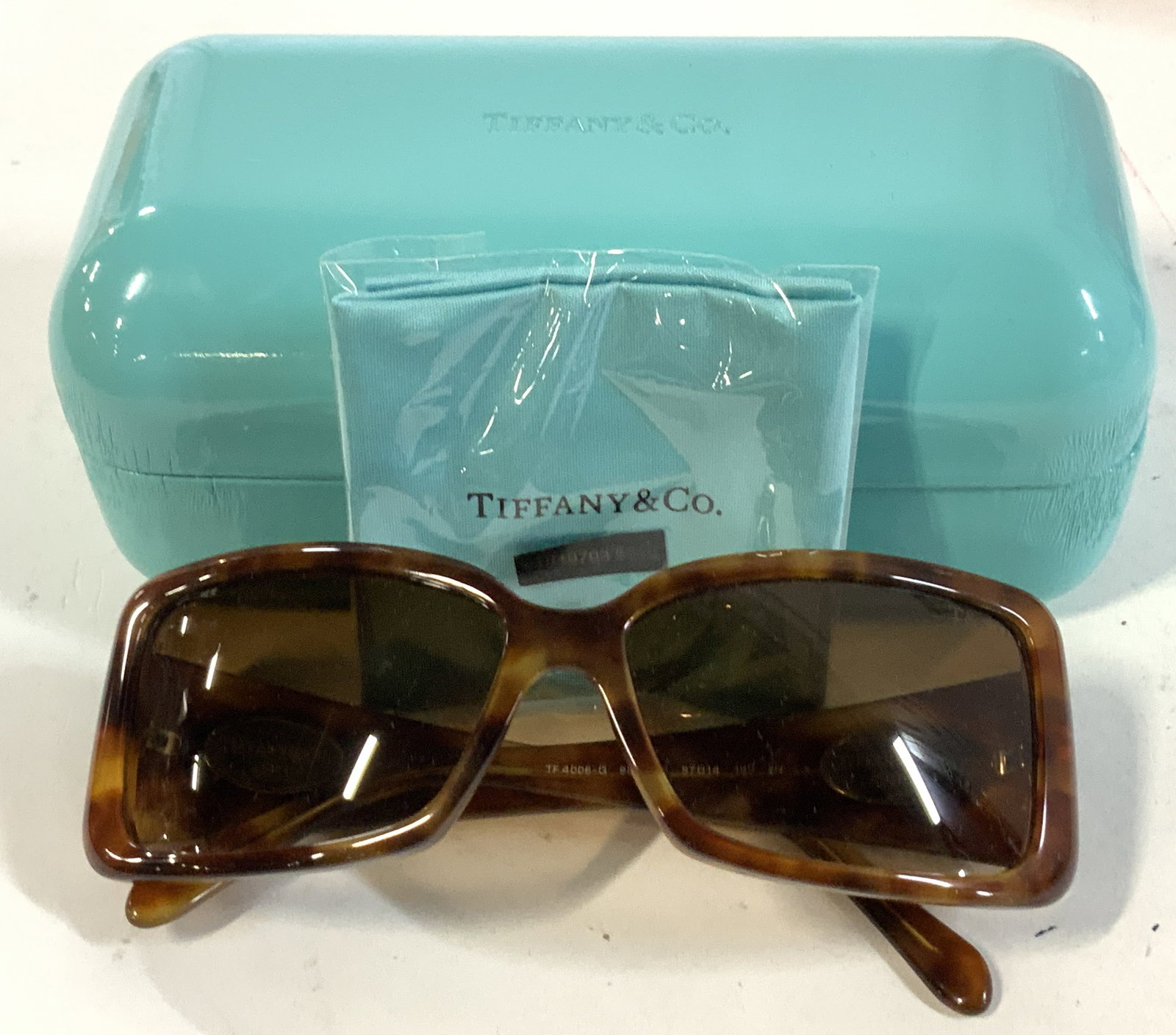 Tiffany & Co Sunglasses w Sterling Accents, Case: Rectangular Tiffany & Co Sunglasses ( no prescription lens). Trademarked Tiffany & Co New York on Sterling silver accents. Total 4 oval sterling silver accents on sunglass arms . Sunglasses are made i