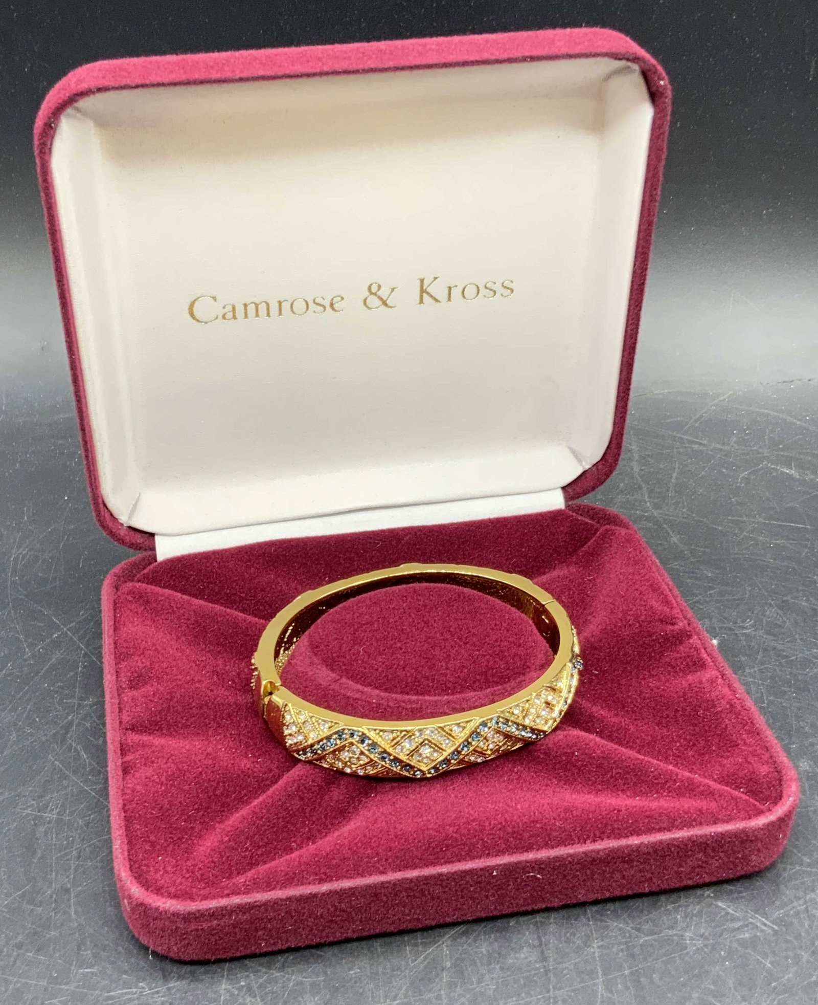 Camrose & Kross Vtg JBK Bejeweled Crystal Bracelet: A vintage JBK Camrose & Kross JAQUELINE BOUVIER KENNEDY bejeweled Swarovski crystal bracelet. Gold tone bracelet, possibly 24K gold plate, decorated with raised metalwork and blue & clear faceted crys