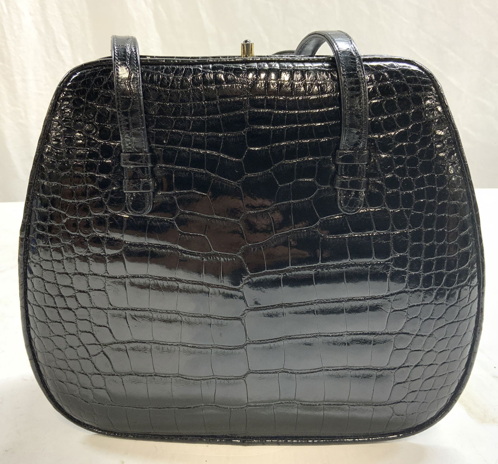JUDITH LEIBER Croc Skin Leather Hand Bag: Marked on interior plaque Judith LEIBER, New York. Includes dust bag. Hand bag made with black croc skin leather on exterior and handle with leather interior and textured fabric pocket interiors. Hand