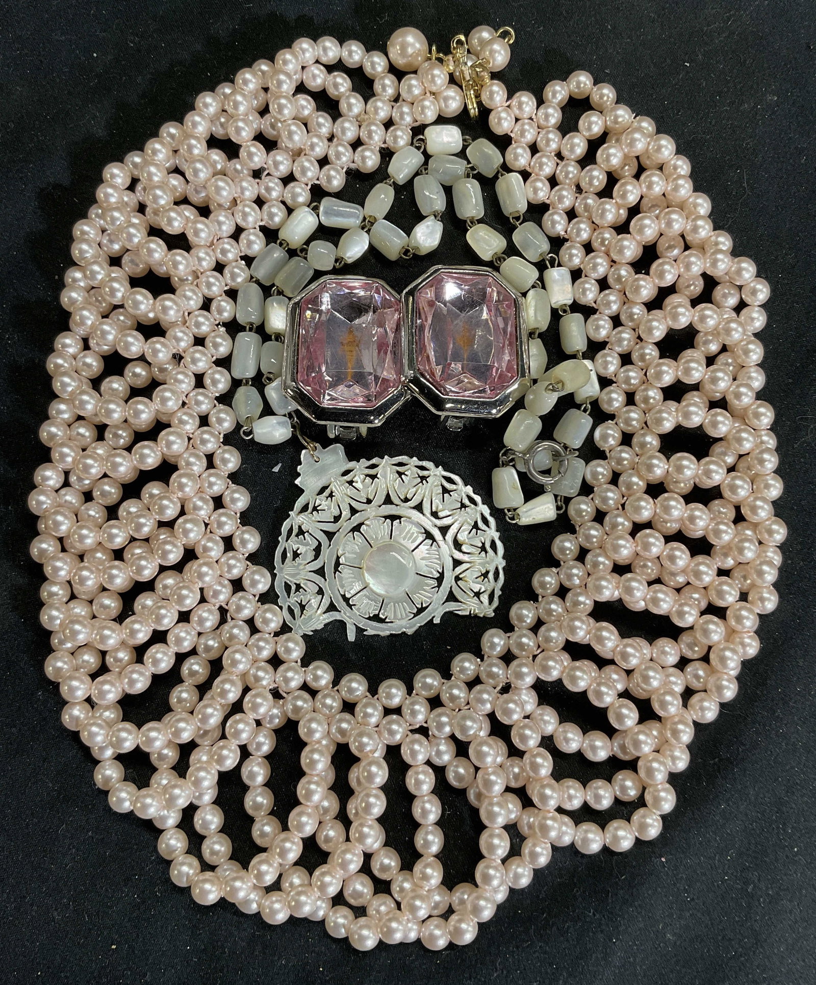 Lot3 Jewelry, Necklaces and Earrings: Four pieces include pink toned pearl collar necklace overlapping loop design. Width 2in drop 7in. Mother of pearl bead and pendant necklace. Pendant broken. XL pink faceted clip on earrings with silve