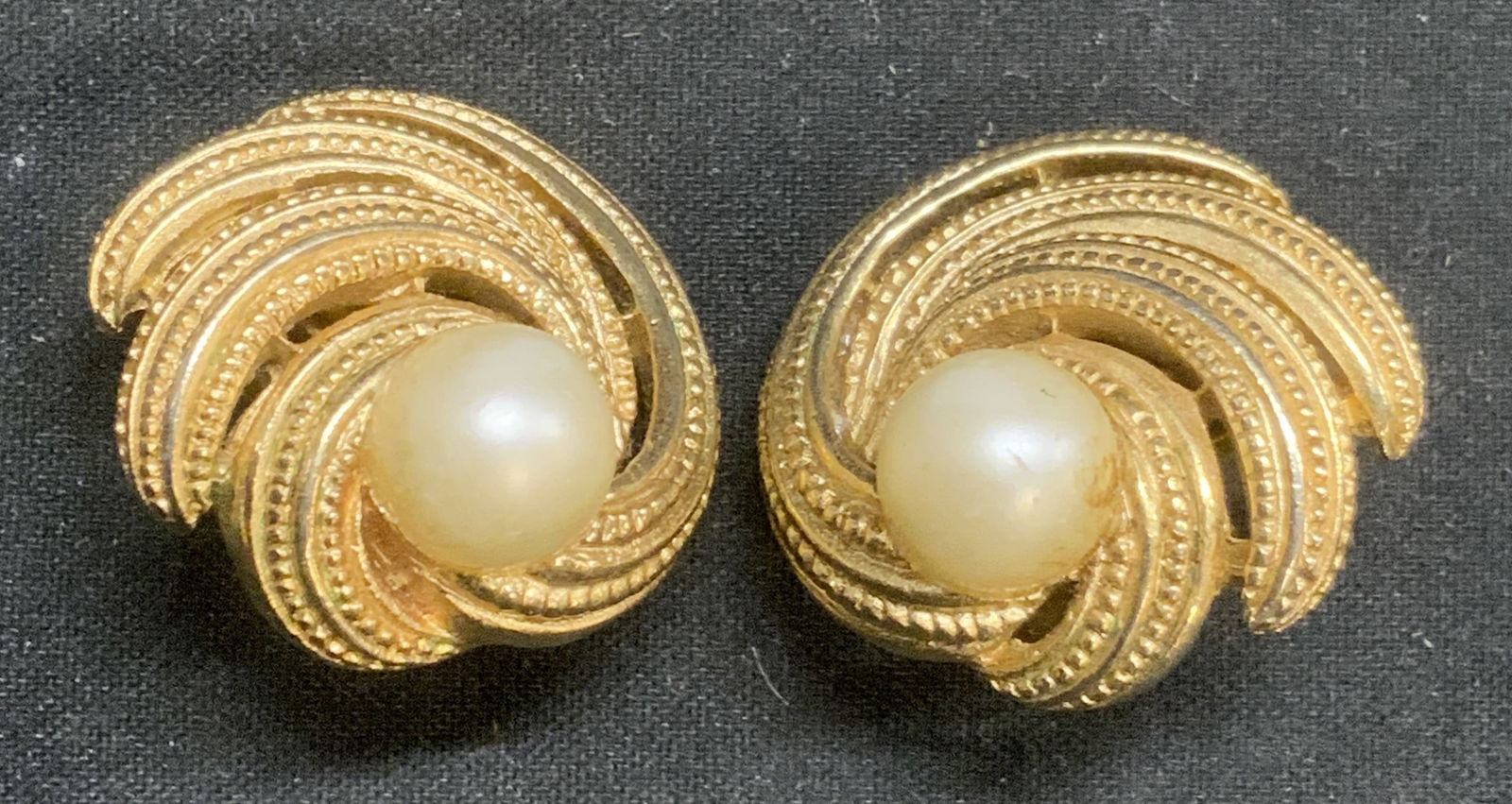 TRIFARI Vtg Gold Tone Faux Pearl Earrings: Vintage Trifari gold tone clip on earrings with faux pearl cabochons. Designer label to backing. Some surface wear consistent with exposure. Measure approx. 7/8 inches diameter. Estate jewelry, costum