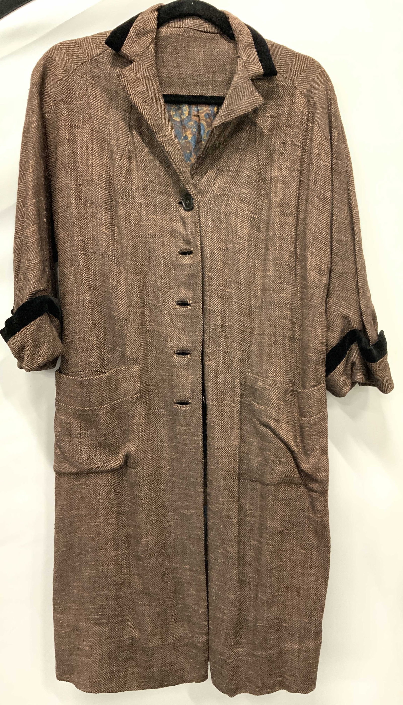 Tweed Style 3 Quarter Sleeve Jacket: Tweed style button up jacket with three quarter sleeeves and two front pockets. Interior lining, possibly made of cotton has a colorful blue and yellow paisley design. Jacket possibly made of wool or 