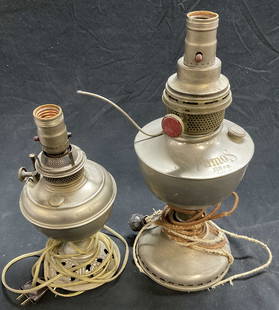 Lot 2 Vintage Oil Converted to Electric Lamps: Two vintage oil lamps converted to electric. B&H Bradley Hubbard nickel toned oil lamp converted to electric. Stamped B&H. Measures approx. 11.5T x 5.5W in. Measured at widest points. FAMOUS 120 c.p.