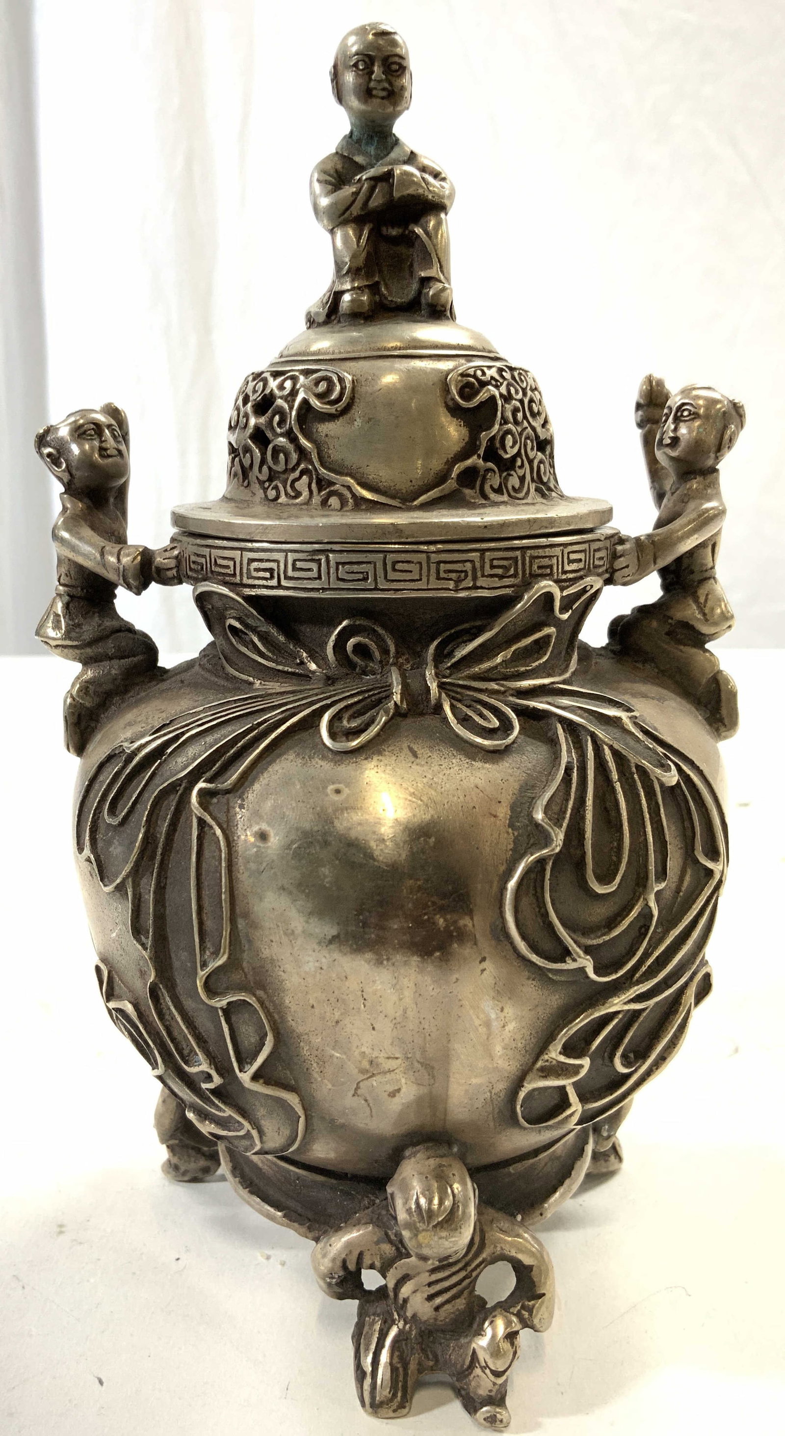 Signed Silvered Brass Lidded Asian Incense Burner: Incense burner is signed with Asian characters on underside. Piece has 2 figural handles, 3 figural feet & figural top to lid. Piece appears to be silvered brass 7.5 inches tall 4.25 inches wide. Ince