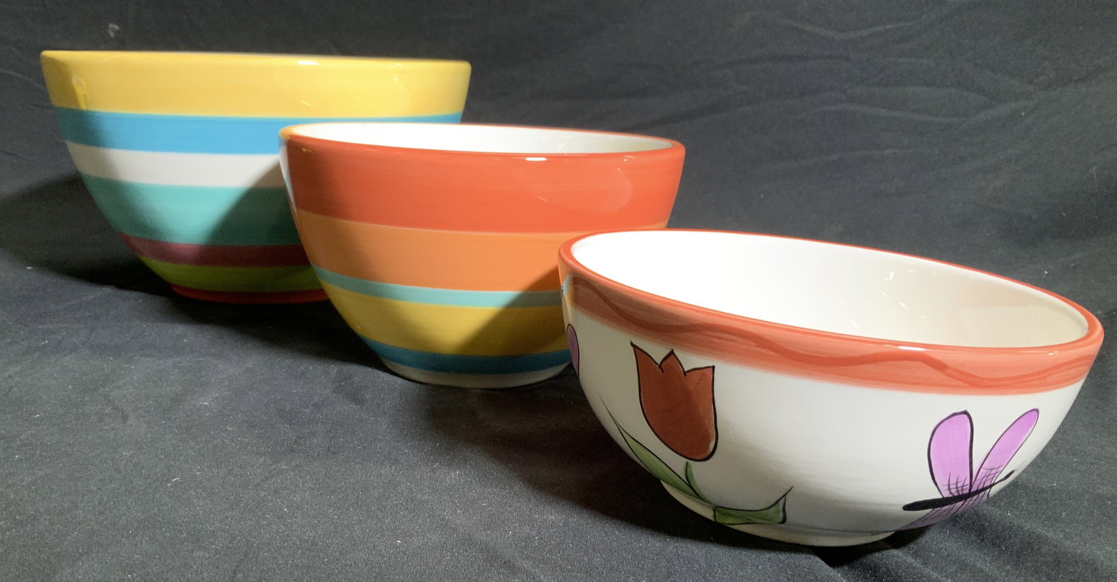 Crate&Barrel Colorful Porcelain Bowls: Crate&Barrel hand painted porcelain bowls with colorful stripes. Large bowl measures 9.25 in. Diameter , 5.25 in. Ht. Coordinating flower and dragonfly brown measures app 6.5 in diameter, 3 in. Ht. Th