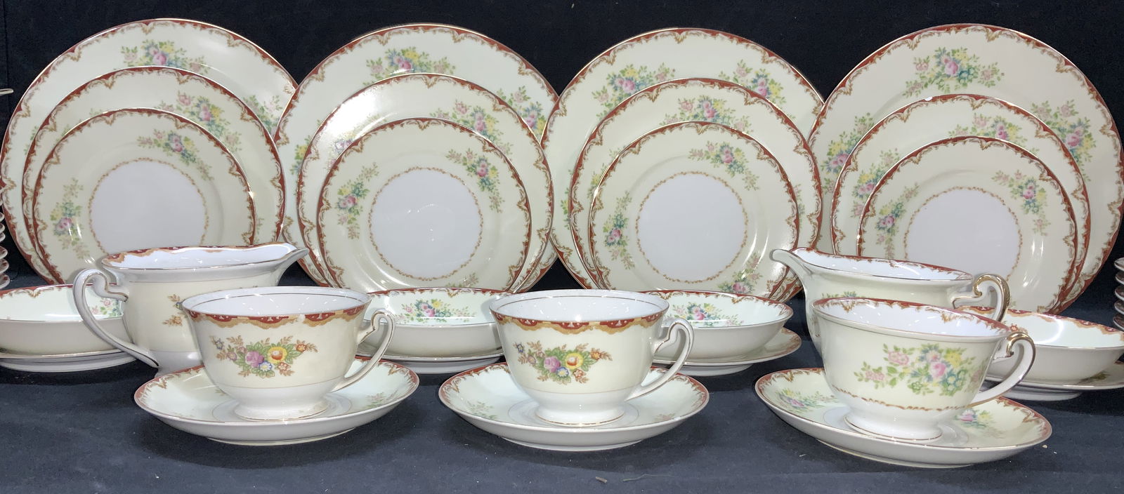 Set 94 N.S.P.C. Hand Painted Japanese Chinaware: White and cream chinaware hand painted with pink, green and yellow florals and accented with a Victorian edge scroll in gold and Rusty orange. Large set of dinner plates, luncheon plates, dessert plat
