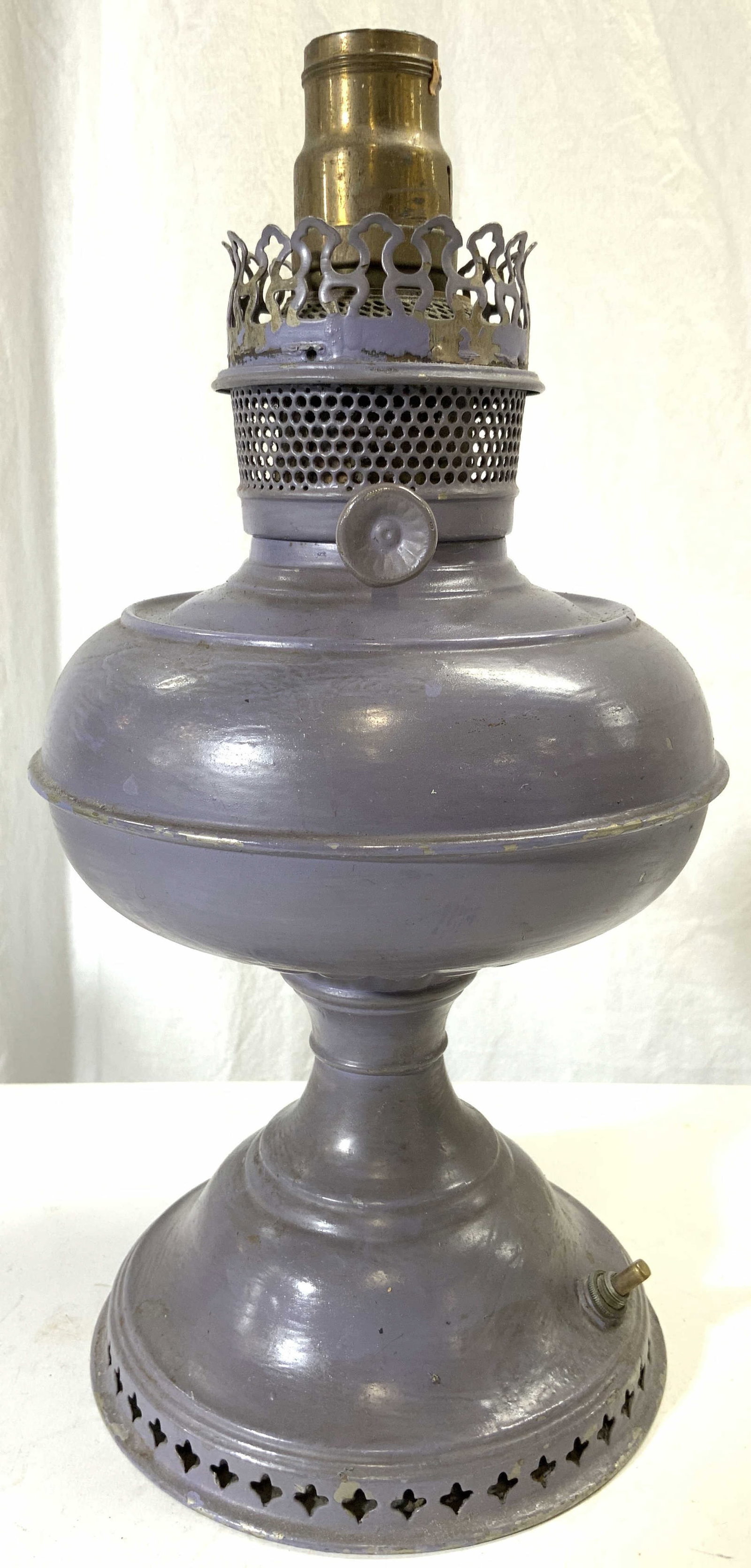 Vintage Electrified Kerosene Metal Oil Lamp: Lamp is vintage possibly antique. Piece is slate purple toned and metal. Base has pierced detail. Side near top has knob. Piece measures approximately 13.5 inches tall 7 inches wide. Lamp, electrified