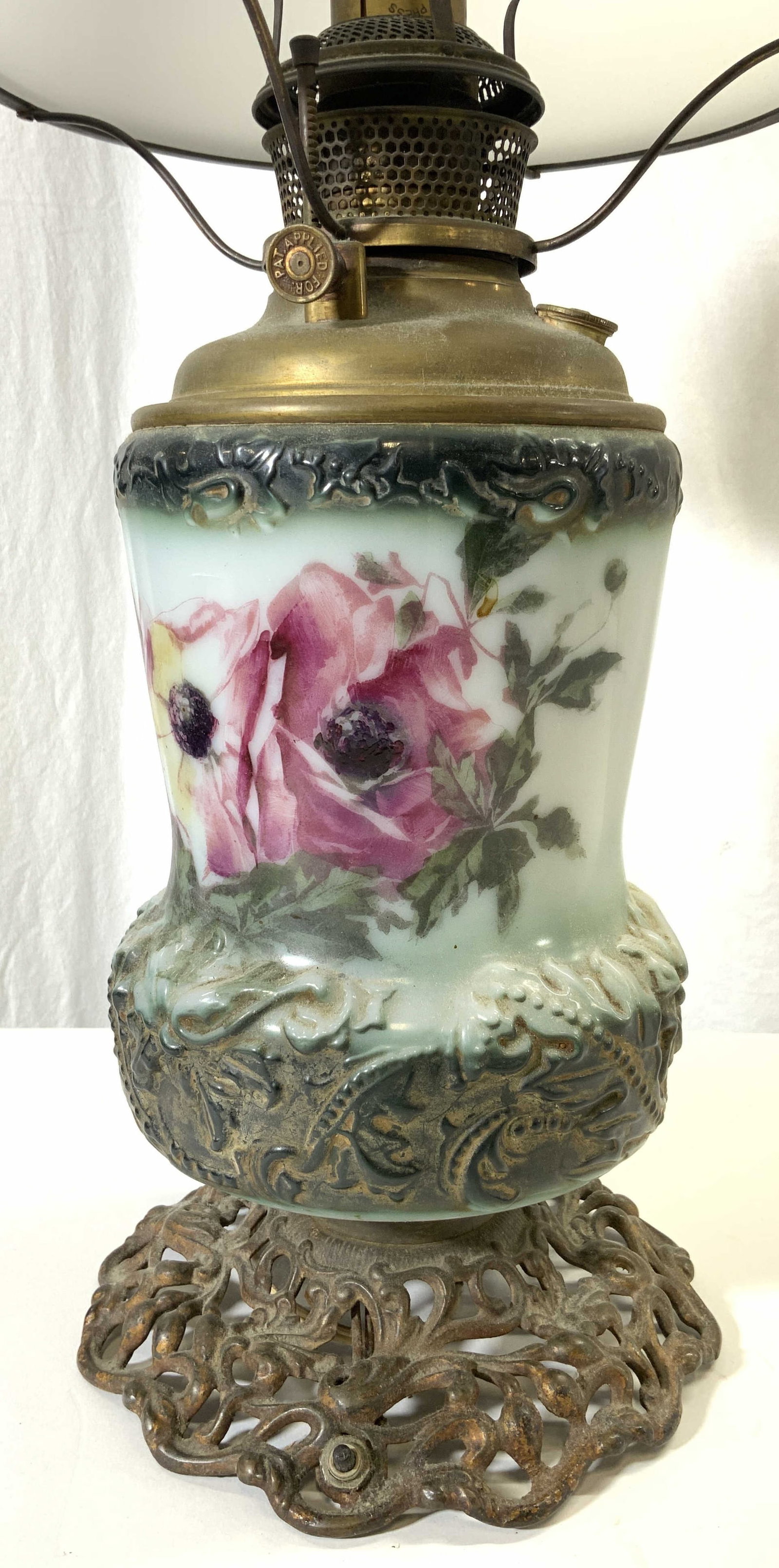 B&H Glass & Metal Gone With The Wind Lamp: Lamp reads B&H. Lamp is vintage possibly antique. Piece has metal base with ornate and pierced detail. Some elements may be hand painted with multi toned floral & leaf detail. Includes white toned gla
