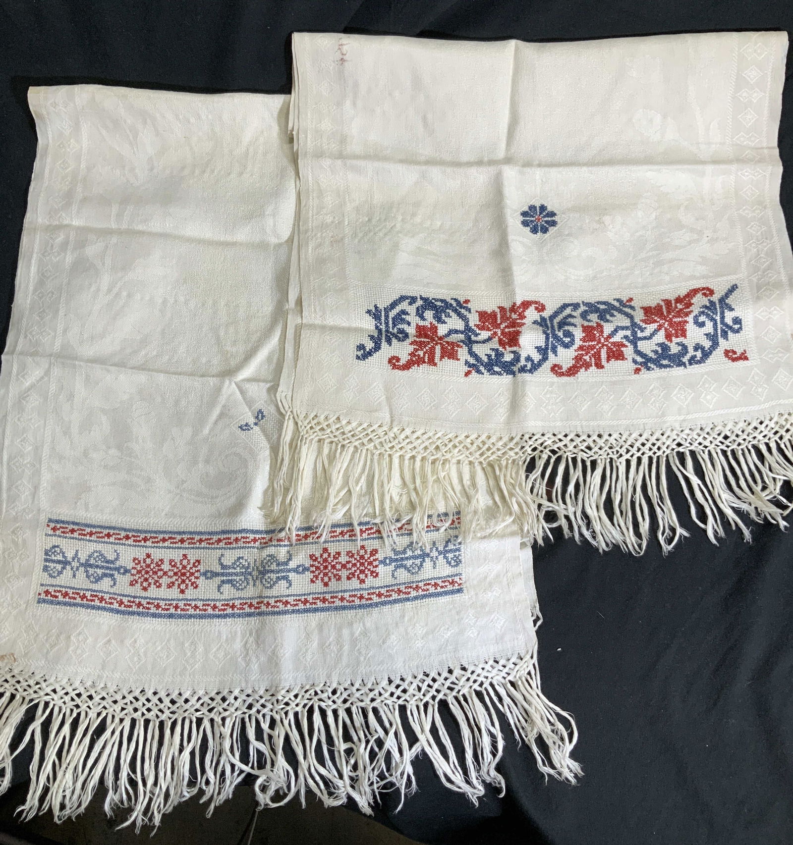 Cross Stitch Linen Table Runners w Tassels, 2: Hand stitched on cream linen , blue and red Cross stitch holiday motif, jacquard linen ( mixed with rayon) with nut & oak leaf motif. Each measures 18 x 51 in. Some blemishes consistent with use and e