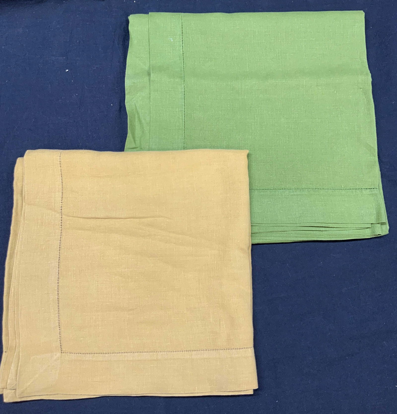 Two 50 x 50 Inch Cotton Table Cloths: Lot of 2, possibly cotton solid color table cloths. Approx 50 inch x 50 inches Moderate blemishes to edges of cloths. Cotton table cloths, tablecloths, kitchen accessories and decor, home decor. Table