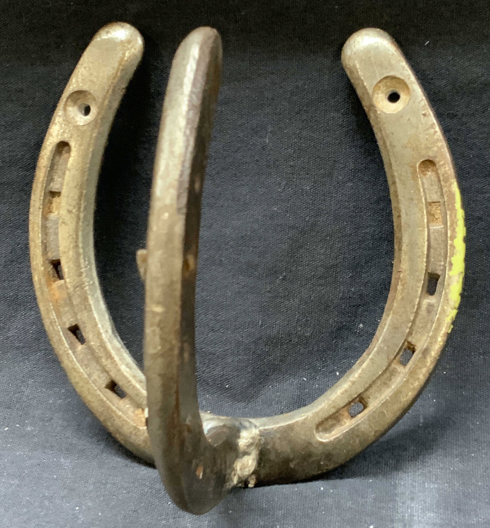 Arts & Crafts Iron Horse Shoe Wall Hook: Arts and crafts wall hook made with horse shoes, stamps Don backside of hook, illegibly. Approx 4.75 inches long and 4.75 inches wide. Evident wearing and oxidation to iron throughout. Vintage hook, w