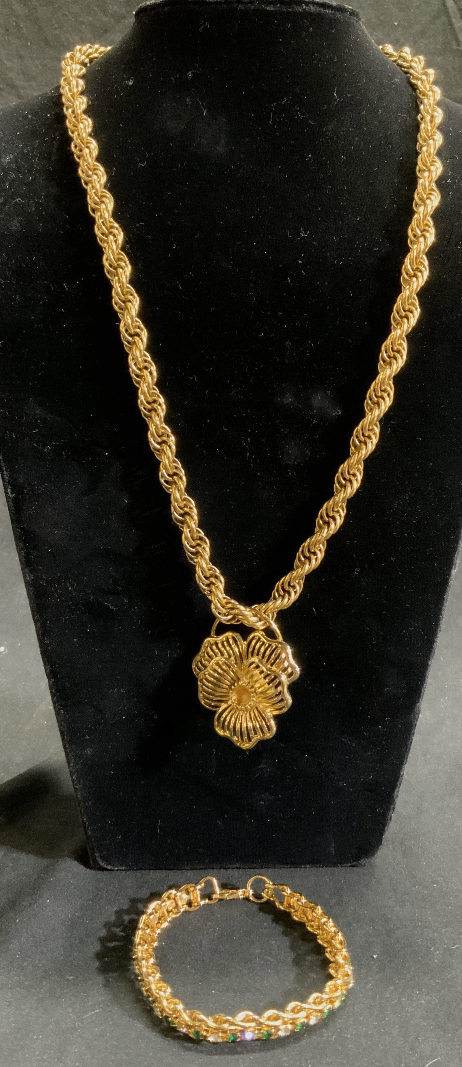 MONET Gilt Metal Pendant Necklace & Bracelet: Clasp of necklace reads MONET. Necklace is gilt metal. Necklace has flower pendant. Bracelet has green & clear Rhinestone detail. Necklace Drop measures approx 10 inches, pedant 1.5 inches wide. Neckl