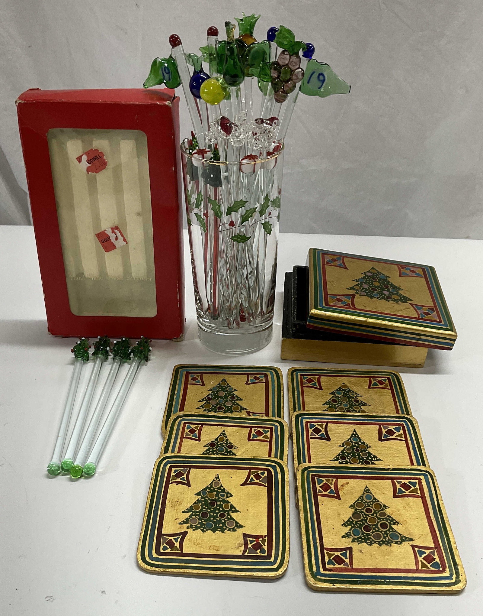 Lot 3 Holiday Barware Hand Made india: Multiple Blown Glass Holiday swizzle sticks in highball glass with holly design. Longest stick measures approx 8in. Shorter sticks 6in. Vintage Drulane Designs hand made glass stirrers in box. Stirrer