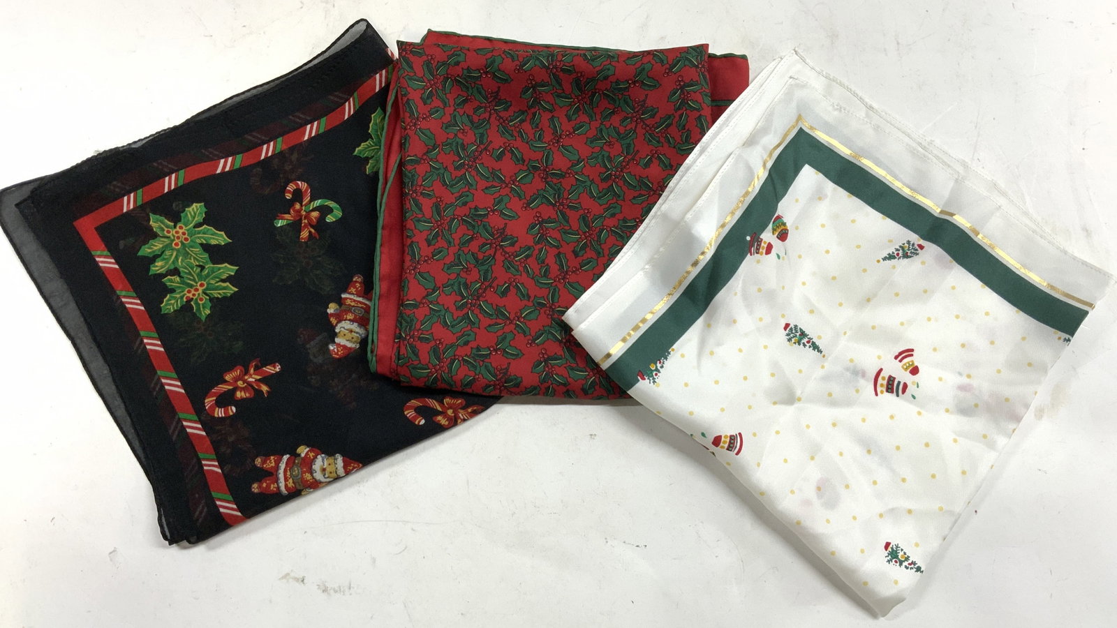 TALBOTS, ALYNN, SIMPLY ACCESSORIES Xmas Slk Scrves: Lot includes 1 scarf with tag which reads TALBOTS (white with ornament & Christmas tree detail), New with tag, 1 scarf with tag which reads ALYNN (red with mistletoe detail), & 1 scarf with tag which 
