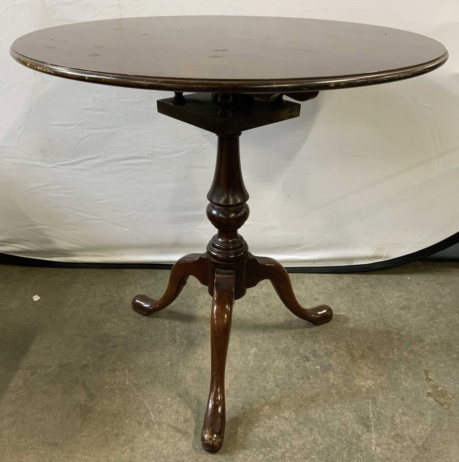 Vintage Wooden Pedestaled Tilt Top Table: Table is vintage and wooden. Piece has pedestaled base and circular shaped top. Table has tilting top. Piece has carved detail. Measures approx 29 inches tall 30 inches diameter. Table, wooden table, 