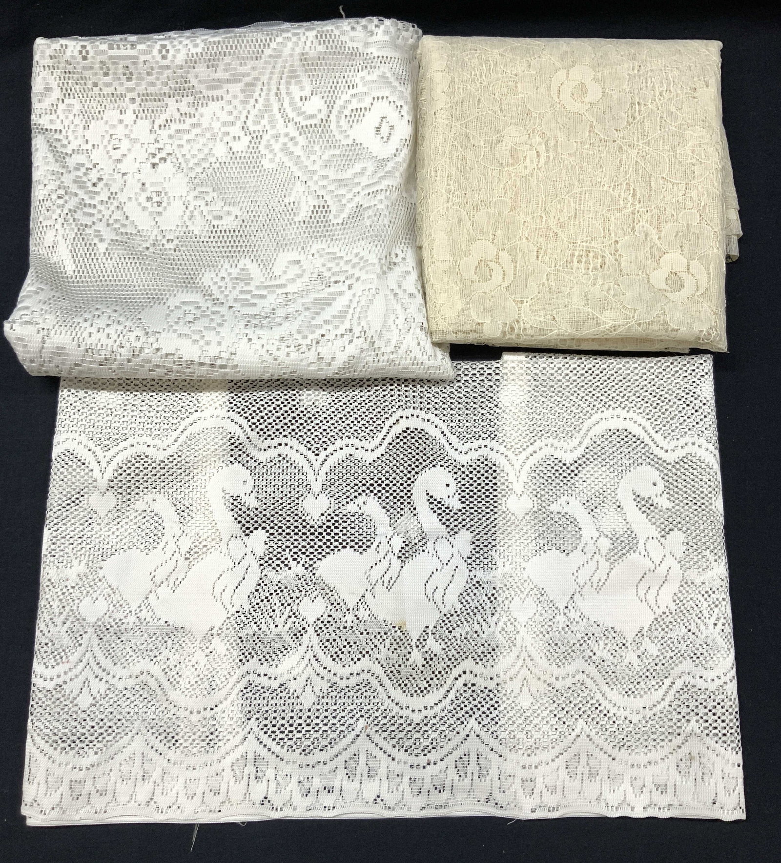 Lot 3 Vintage Lace Curtains: Lot of 3 vintage curtains. 1 lace curtain, off white with floral motifs, approx 58 inches wide and 60 inches long. 1 white curtain, possibly cotton, soft hand, approx 45 inches long and 42 inches wide