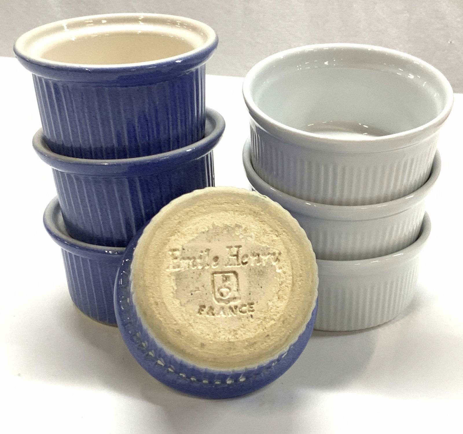 Lot 7 Dansk & Emile Henry France Ramekins: Set 3 White porcelain ramekins, Made In Portugal, signed Dansk, measure 3.75 x 1.5 in. Set of 4 Earthenware blue ramekins, made in France , signed Emile Henry, measure 3.5 x 2 in. Ramekins, Bakeware,