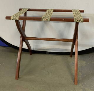 Vintage Stitched Floral Motif Luggage Rack: A foldable wooden luggage rack with cloth stitched floral pattern straps. Carved wood stretcher. X form legs. Measures approx. 20H x 22.5W x 13D in. Some surface wear and losses to finish. Property fr