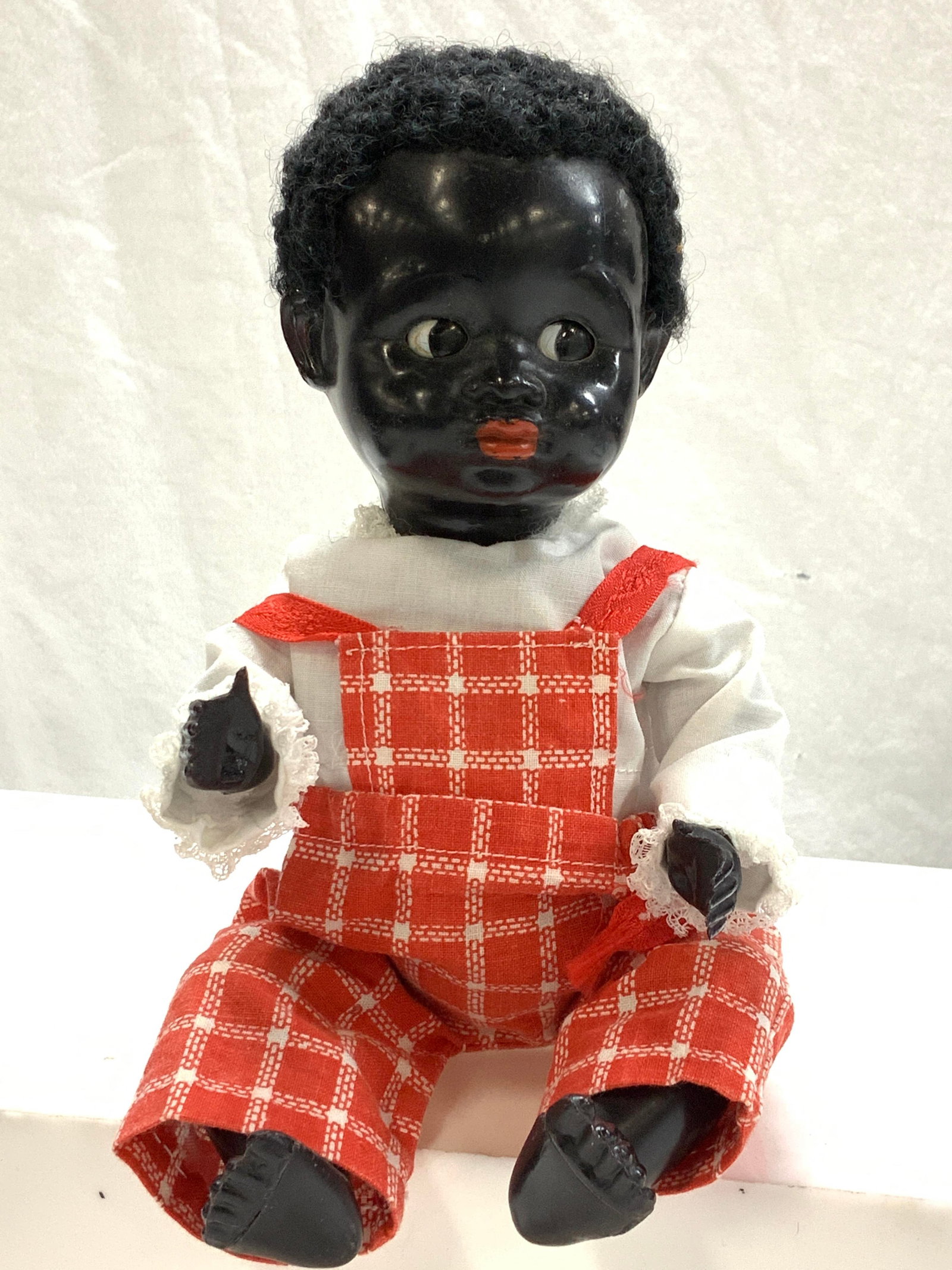 Vintage Baby Doll, Made In England: Vintage baby doll, marked made in England.wearing red overalls and a white shirt. Eyes open and close. Legs and arms move, and head turns. 10 x 5 in. Vintage Baby Doll, Made in England Doll, Childs Vi
