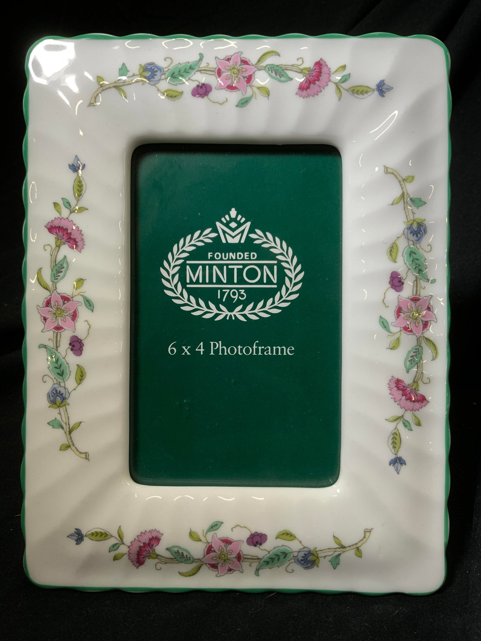 MINTON Vintage Porcelain Photo Frame: Frame is trademarked MINTON. Piece is white with multi toned floral, vine & leaf detail. Window measures 3.25 inches wide x 5.25 inches tall, outer area 8.5 inches tall 6.5 inches wide. Frame, picture