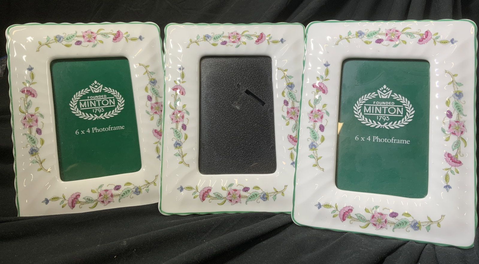 MINTON Set 3 Vntg Porcelain Photo Frames: Frames are trademarked MINTON. Pieces are white with multi toned floral, vine & leaf detail. Window measures 3.25 inches wide x 5.25 inches tall, outer area 8.5 inches tall 6.5 inches wide. Frames, pi