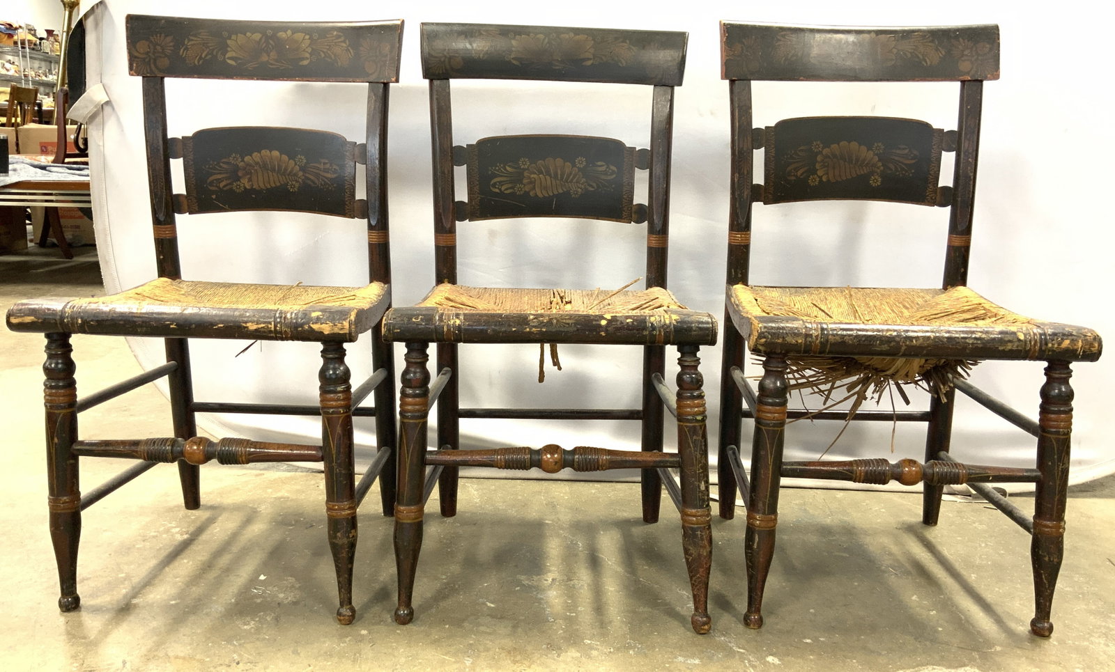 Set 3 Antique Wooden Hitchcock Chairs: Lot includes 3 chairs. Each are antique and wooden. Chairs are Hitchcock style. Each have rattan seats & box stretchers in between legs. Chairs measure approximately 33.5 inches tall 17.5 inches wide 