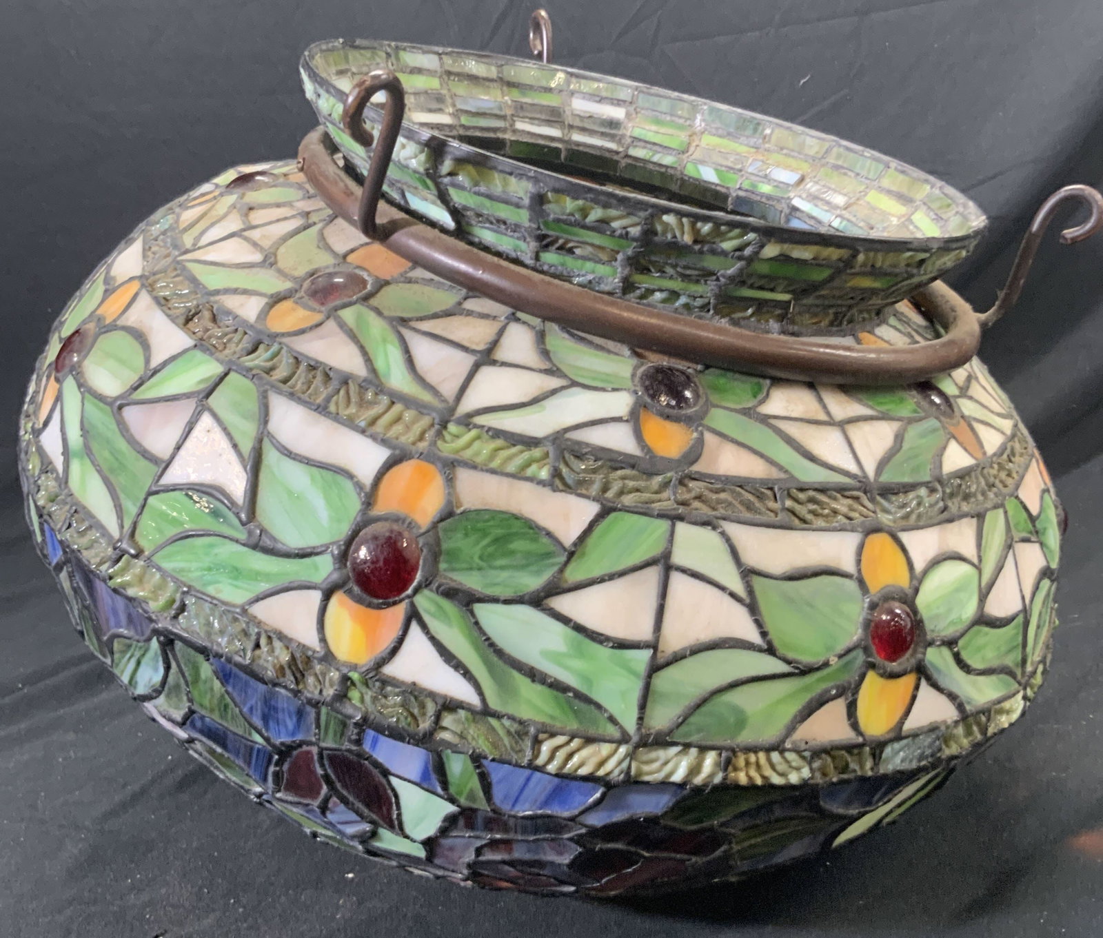 Tiffany Style Floral Slag Glass Lampshade: Tiffany style floral slag glass lampshade. Multicolored hues. Metal hardware around mouth of lampshade features three curled hooks. Measures approx. 12 inches in height including metal hardware, width