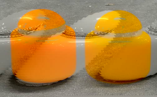 Lot 2 Vintage Orange Lucite Trinket Boxes: Lot of 2 vintage orange lucite, possibly Bakelite, and metal trinket boxes. Measure approx. 1 7/8 x 2 7/8 inches. Some surface wear to each consistent with exposure. Property from F.W. WOOLWORTH CEO B
