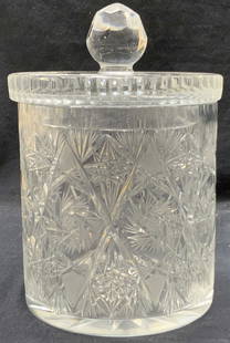 Thick Walled Cut Crystal Lidded Vessel: Thick wall cut crystal lidded vessel with cut Star burst designs and x patterns. Lid has faceted top sphere handle. Approx 10 inches tall and 6 inch diameter. Moderate wearing to surface and underside