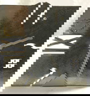 Metalwork Mantel Clock Desk Clock: Clock is silver toned and metal. Piece has square shaped structure. Clock stand on its own. Piece has pierced geometric detail. Piece has light slate toned hands. Clock measures approx 3.85 inches tal