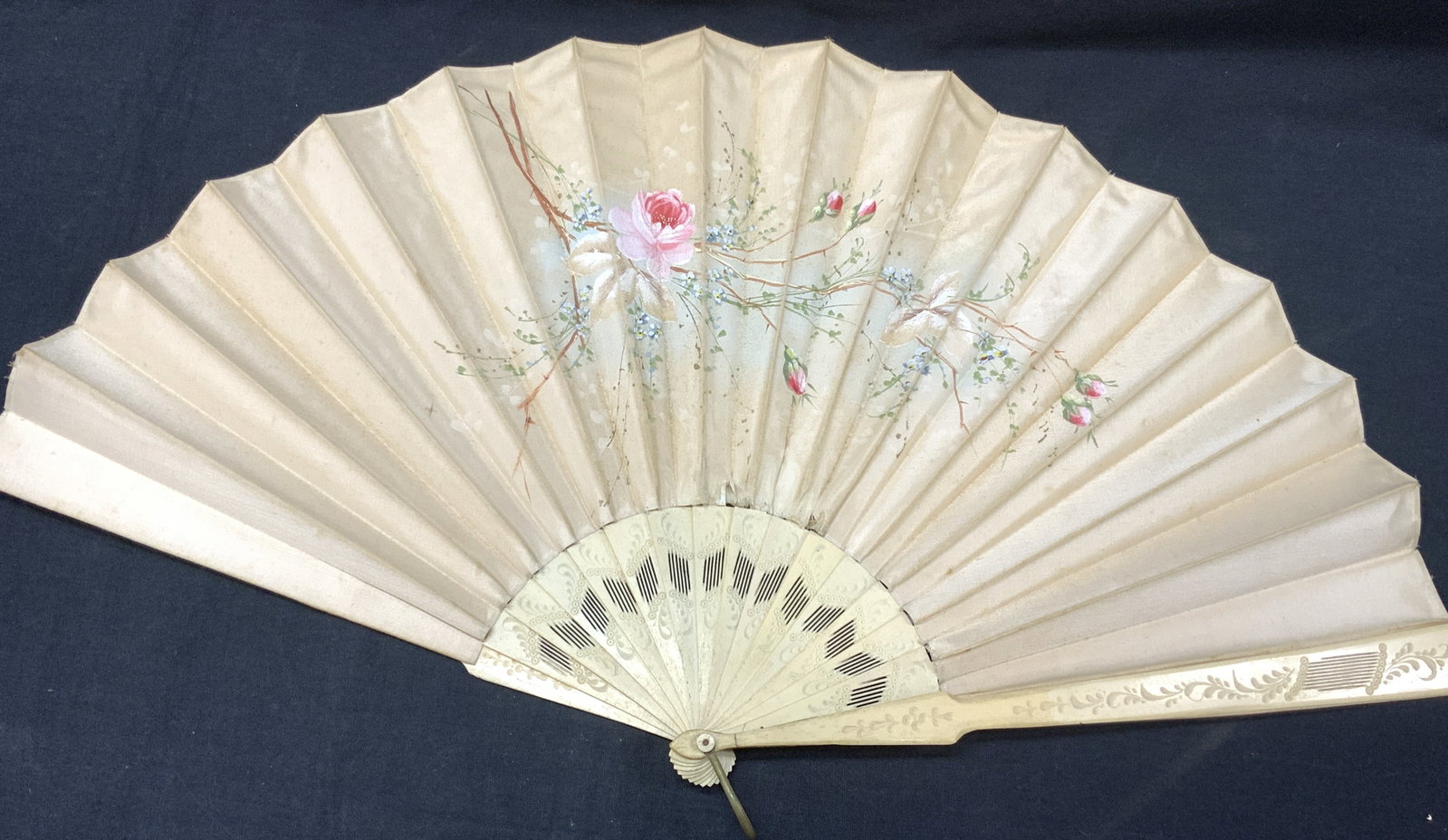 Carved Bone & Hand Painted Fan: Vintage folding fan, with frame possibly made of odd white bone with decorative carvings. Fabric is hand painted with pink roses. Approx 2ft wide unfolded, and 12 inches long folded. Evident wearing a
