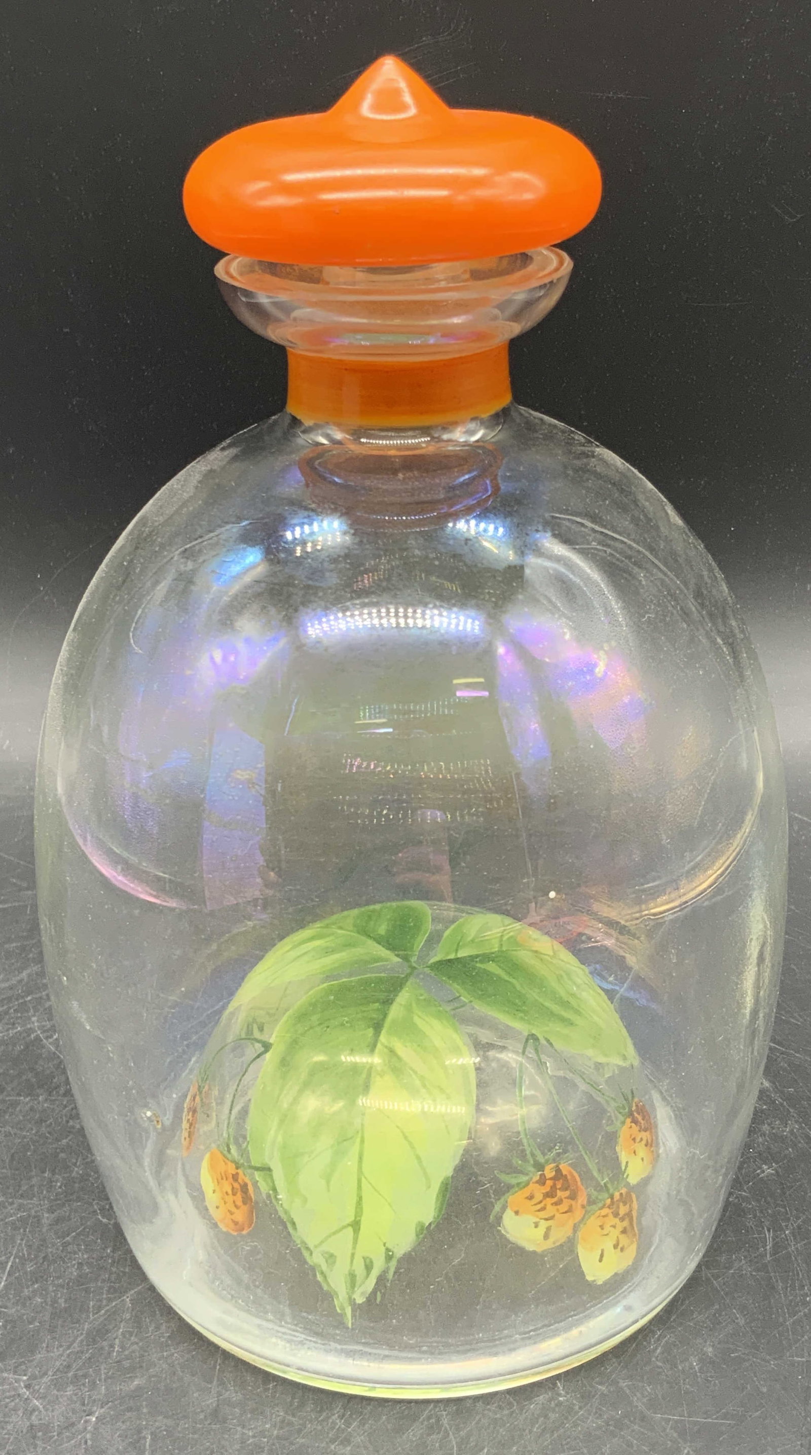 Vintage Hand Painted Art Glass Decanter W/ Lid: A vintage art glass decanter featuring hand painted foliage and berries to the underside. Glass has a slight iridescence. Underside features impressed bubble style glass dome. Painted orange glass lid