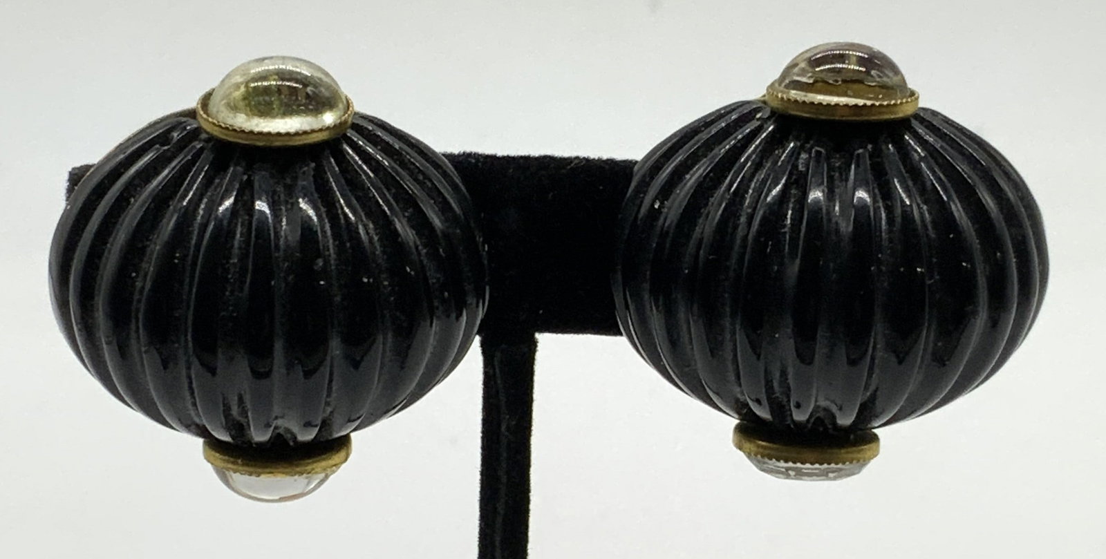 Vintage Black Sculptural Lucite Earrings: Vintage gold tone sculptural black lucite and transparent Cabochon clip on earrings. In the style of Fabrice Paris. Unsigned. Measure approx. 1.25 x 1.25 inches. Some scratching observed. Property of 