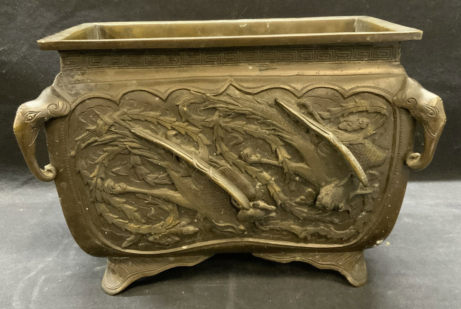Stamped Chinese Bronze Phoenix & Dragon Planter: Vintage stamped Chinese bronze planter with Phoenix, dragon, foo dog, and elephant motif. Measures approx. 10.25 x 6.25 x 8 inches. Tarnishing and scratching observed. Chinese planter, bronze planter,