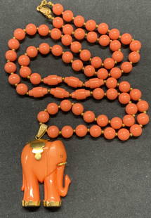 MIRIAM HASKELL Coral Tn Elephant Pendant Necklace: Vintage Miriam Haskell coral toned beaded necklace with gold tone seed beads and elephant pendant. Signed on clasp. Drop length approx. 14 inches. Pendant measures approx. 1.5 x 1 1/8 inches. Some sur