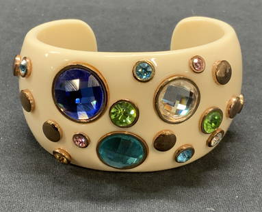 Chunky White Multi Color Crystal Cuff Bracelet: Chunky white toned acrylic cuff bracelet with multi color crystal and gold tone decoration. Measures approx. 2.5 inches wide, cuff approx. 1 5/8 inches. Some surface wear including scratches observed.