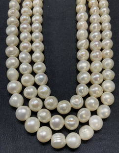 3 Strand White Pearl Necklace, 807 Carats: Vintage 3 strand white pearl necklace. Champagne and rose undertones. Drop length of shortest strand approx. 8.5 inches. Some surface wear consistent with exposure. Total weight 807.5 carats. Estate j