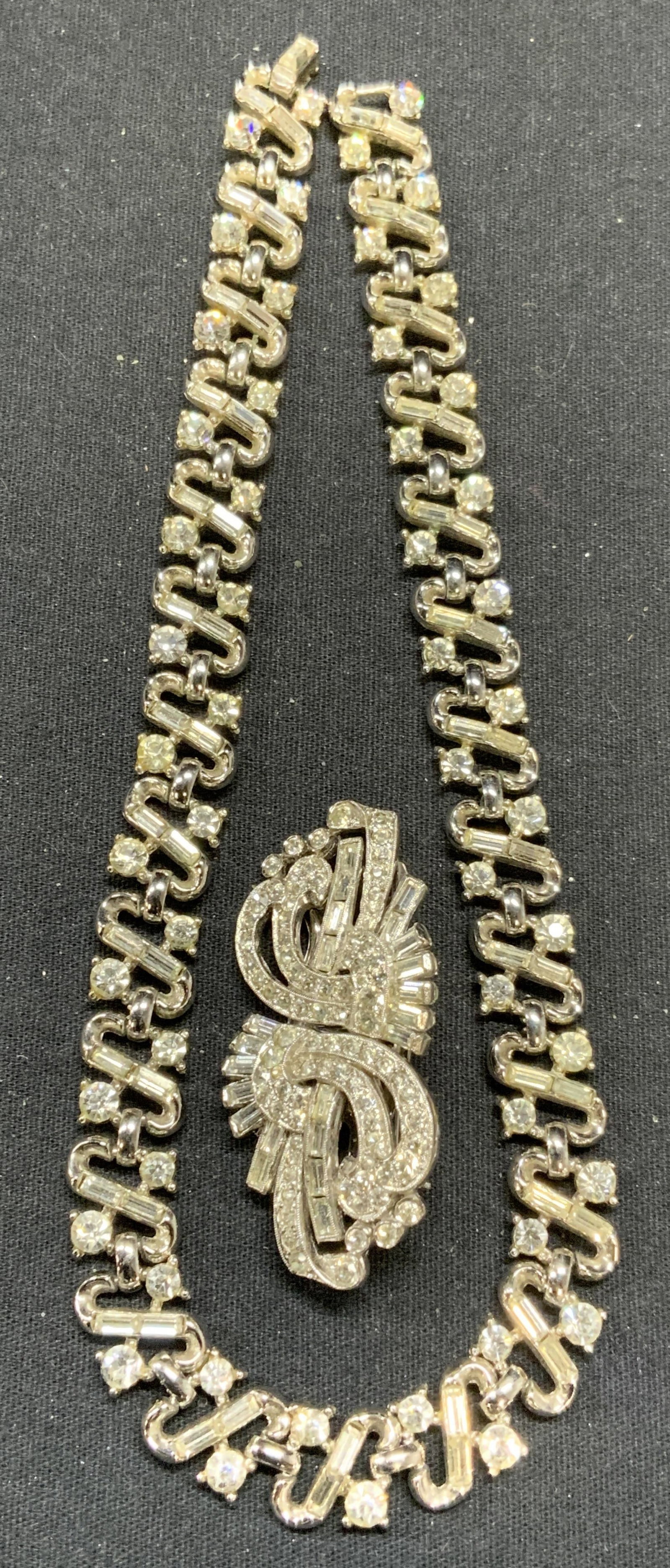 2 ENGEL Fur Clip Brooch, TRIFARI Crystal Necklace: Lot of 2 jewelry pieces. Vintage Engel silver tone crystal decorated fur clip brooch. Clips are detachable. Signed to underside. Hinge pin to underside. Measures approx. 2.25 x 1 inches. Vintage Trifa