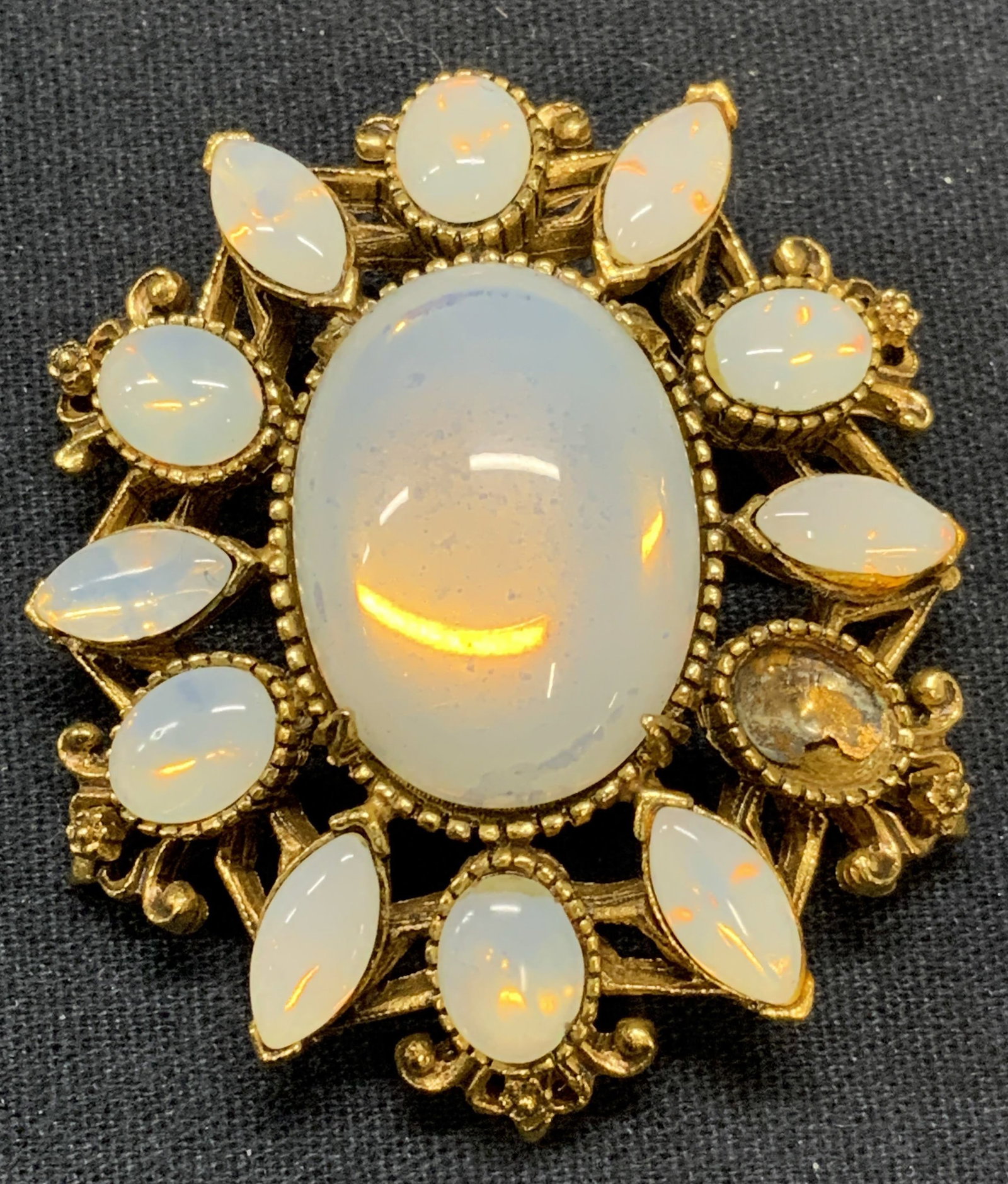 FLORENZA Gold Tone Moonstone Style Brooch: Vintage FLORENZA gold tone brooch with moonstone style Cabochon decoration. Signed to underside. Hinge pin to underside. Measures approx. 1 7/8 x 1.5 inches. One Cabochon needs replacement. Estate jew