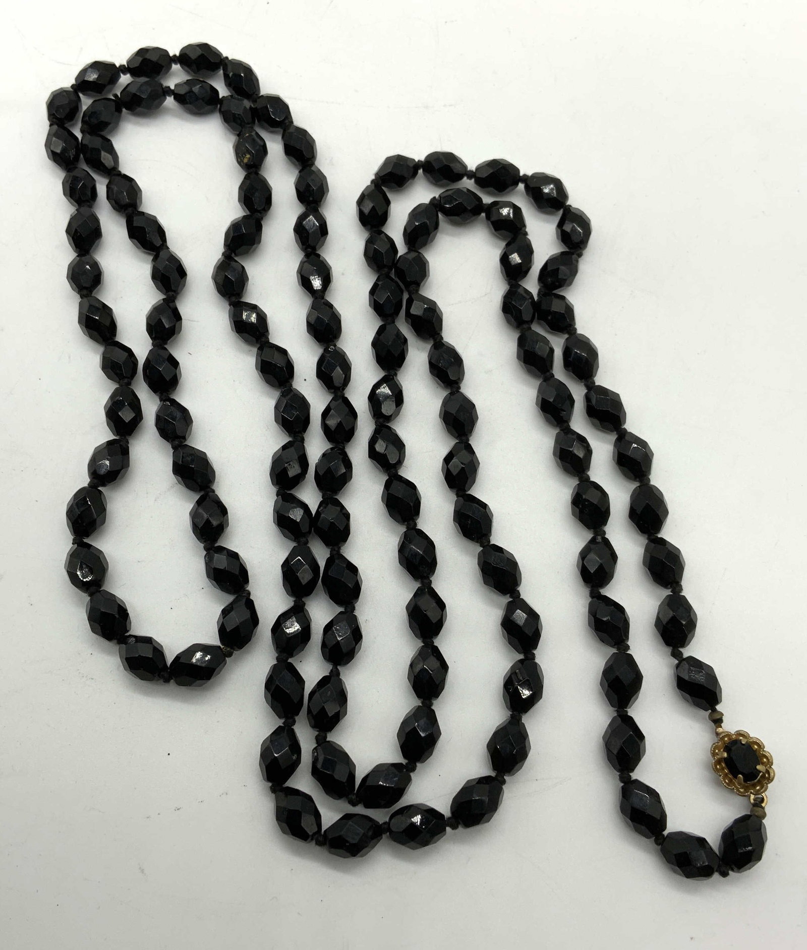 Faceted Black Crystal Rope Necklace: Vintage black faceted glass crystal rope necklace on double knotted string. Drop length approx. 27 inches. Some surface wear including scratching observed. Estate jewelry, costume jewelry, cocktail je