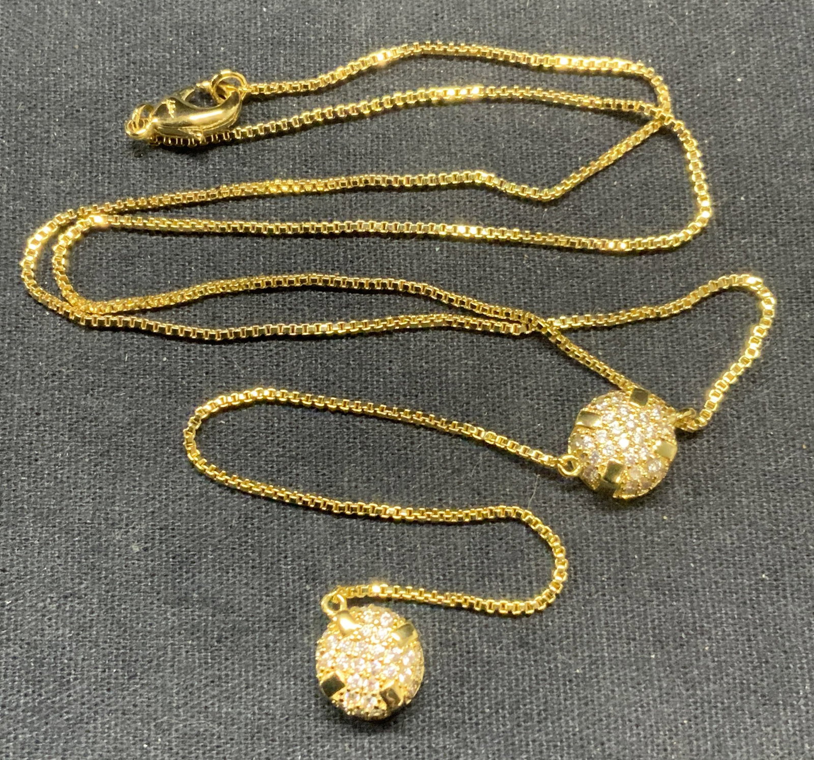Signed Gold Tone Crystal Pendant Necklace: Signed gold tone pendant necklace with crystal decorated pendants. Signed on clasp, illegible. Drop length excluding pendant approx. 8 inches. Pendant drop length approx. 4.25 inches. Some surface wea