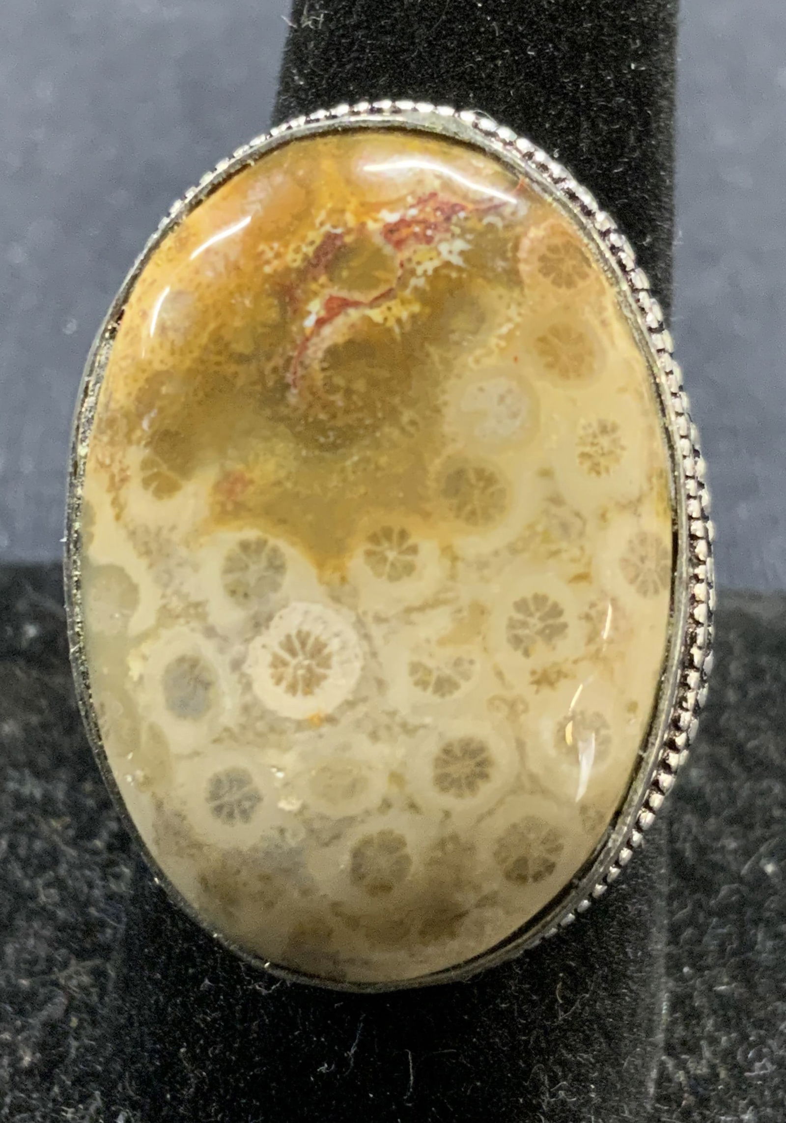 Sterling Silver Fossil Coral Cocktail Ring: Vintage sterling silver ring with fossil coral stone. Marked 925 to interior band. Ring size 9.25. Stone measures approx. 1 x .75 inches. Total weight 12.8 grams. Some surface wear including scratchin
