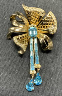 CORO CRAFT Gold Tn Blue Crystal Brooch: Vintage Coro Craft gold tone brooch with colorless and blue crystal decoration. Signed to underside. Hinge pin to underside. Measures approx. 2.5 x 1.5 inches. Some surface wear including scratching o